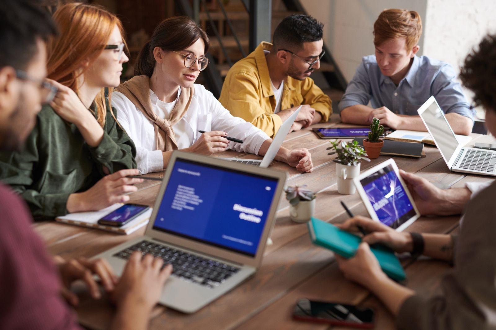 People working together on a laptop at a table